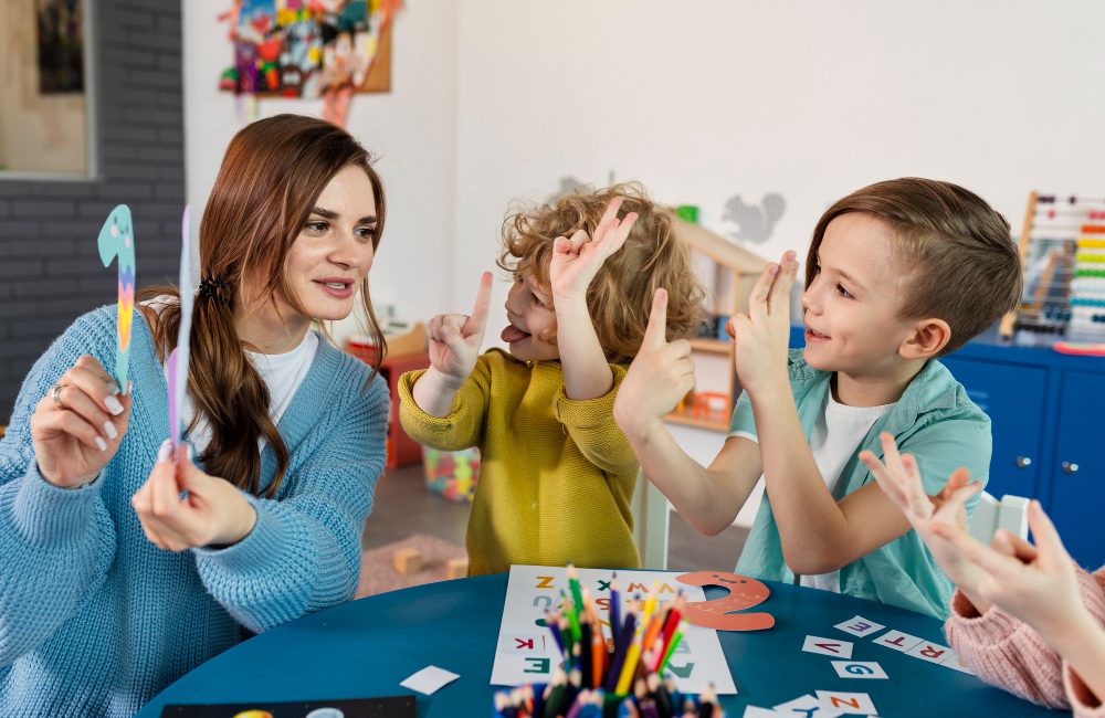 medium-shot-kids-teacher-table medium-shot-kids-teacher-table